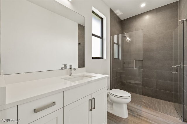 2110 SW 52nd Ter, Cape Coral, FL 33914 - full bath featuring toilet, vanity, a stall shower, wood finished floors, and recessed lighting