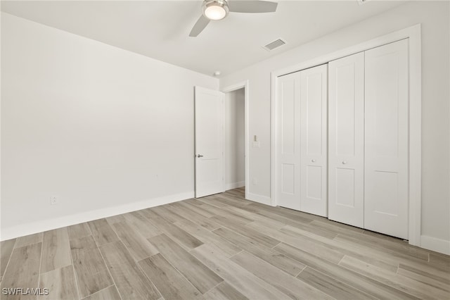2110 SW 52nd Ter, Cape Coral, FL 33914 - unfurnished bedroom with light wood-style floors, a closet, a ceiling fan, and baseboards