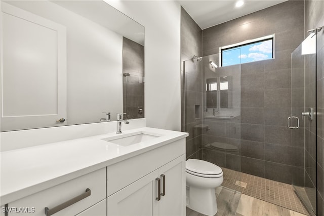 2110 SW 52nd Ter, Cape Coral, FL 33914 - full bath with toilet, vanity, a shower stall, and wood finished floors