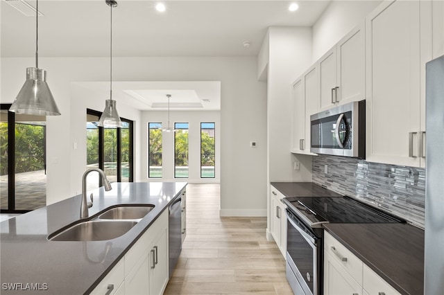 2110 SW 52nd Ter, Cape Coral, FL 33914 - kitchen with stainless steel appliances, a sink, dark countertops, plenty of natural light, and recessed lighting