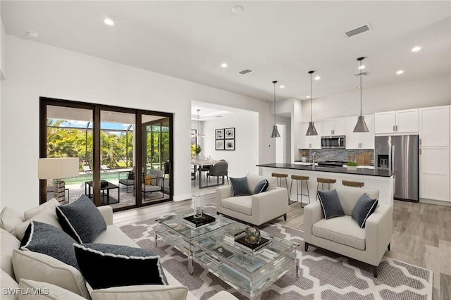 2110 SW 52nd Ter, Cape Coral, FL 33914 - living room featuring light wood-style floors and recessed lighting