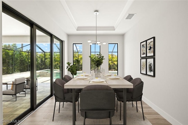 2110 SW 52nd Ter, Cape Coral, FL 33914 - dining room featuring baseboards, a chandelier, a raised ceiling, and light wood finished floors