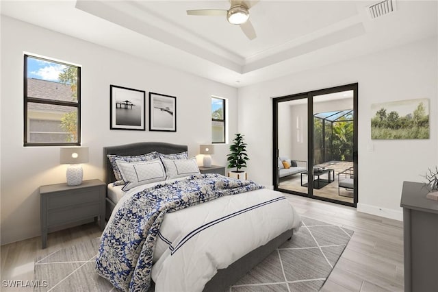 2110 SW 52nd Ter, Cape Coral, FL 33914 - bedroom with a raised ceiling, access to outside, and multiple windows