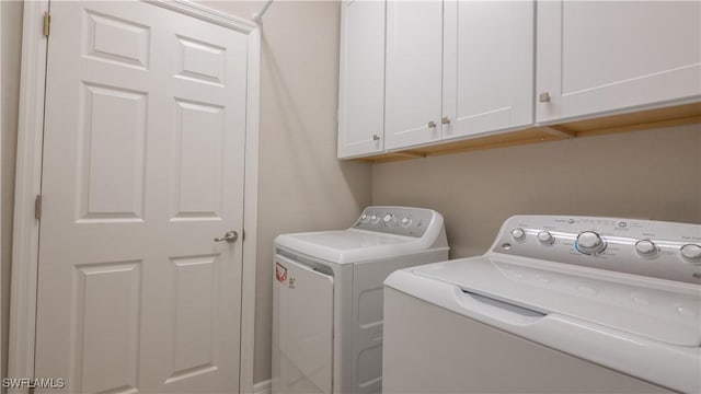 9076 Glenforest Dr, Naples, FL 34120 - laundry area with cabinet space and washer and clothes dryer