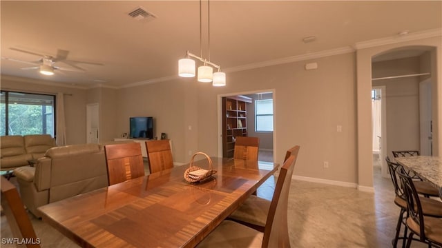 9076 Glenforest Dr, Naples, FL 34120 - dining room with ornamental molding, arched walkways, a ceiling fan, and baseboards