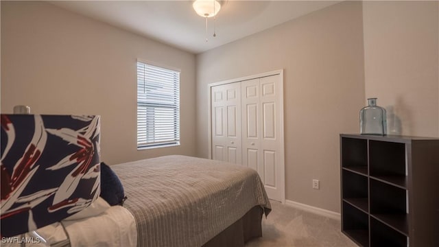 9076 Glenforest Dr, Naples, FL 34120 - bedroom featuring carpet floors, a closet, baseboards, and a ceiling fan