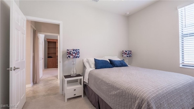 9076 Glenforest Dr, Naples, FL 34120 - bedroom with multiple windows and light carpet