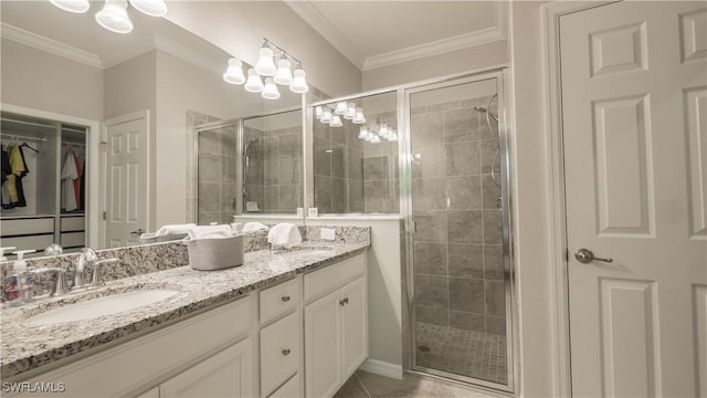 9076 Glenforest Dr, Naples, FL 34120 - full bath featuring double vanity, a stall shower, a walk in closet, crown molding, and tile patterned floors