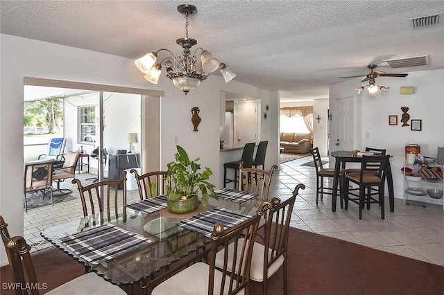 19006 Flamingo Rd, Fort Myers, FL 33967 - dining room with plenty of natural light, light tile patterned flooring, ceiling fan, a chandelier, and a textured ceiling