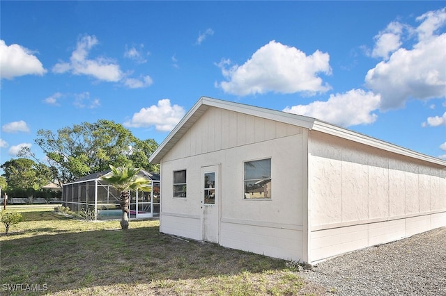 19006 Flamingo Rd, Fort Myers, FL 33967 - view of home's exterior with a lawn and glass enclosure
