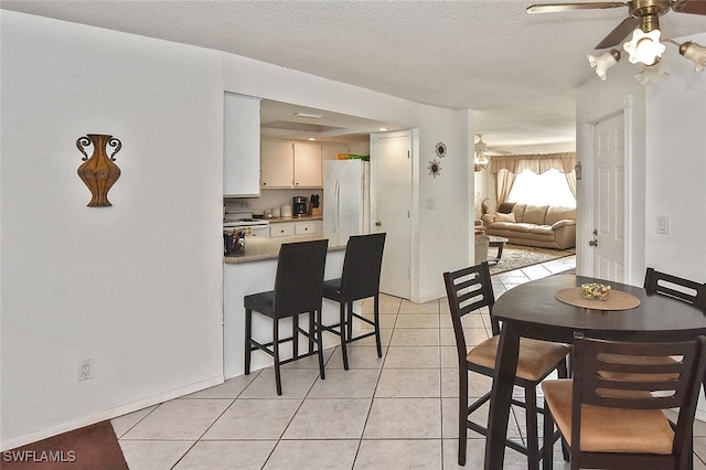 19006 Flamingo Rd, Fort Myers, FL 33967 - dining space with a ceiling fan, light tile patterned floors, and a textured ceiling