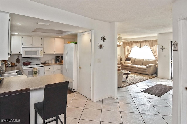 19006 Flamingo Rd, Fort Myers, FL 33967 - kitchen with white appliances, a sink, light countertops, open floor plan, and light tile patterned floors