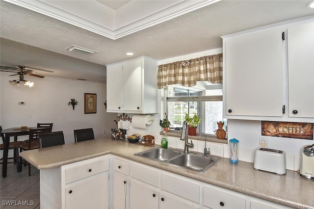 19006 Flamingo Rd, Fort Myers, FL 33967 - kitchen with a sink, ceiling fan, white cabinets, a peninsula, and recessed lighting