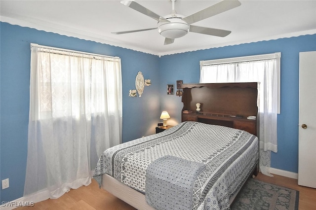 19006 Flamingo Rd, Fort Myers, FL 33967 - bedroom featuring wood finished floors, baseboards, and a ceiling fan