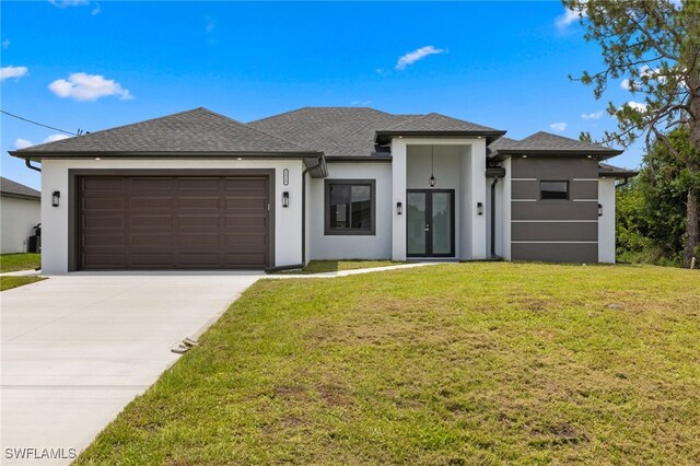2513 13th St SW, Lehigh Acres, FL 33976 - prairie-style home with stucco siding, driveway, a garage, a front yard, and french doors