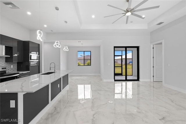 2513 13th St SW, Lehigh Acres, FL 33976 - kitchen featuring modern cabinets, dark cabinets, stainless steel electric range oven, a sink, and a raised ceiling
