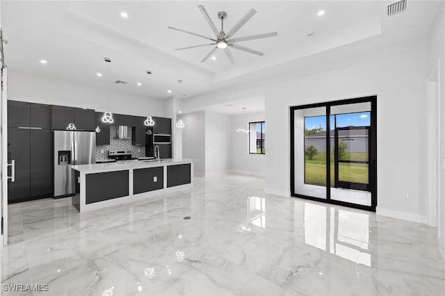 2513 13th St SW, Lehigh Acres, FL 33976 - unfurnished living room with a tray ceiling, a sink, recessed lighting, light marble finish floors, and a ceiling fan