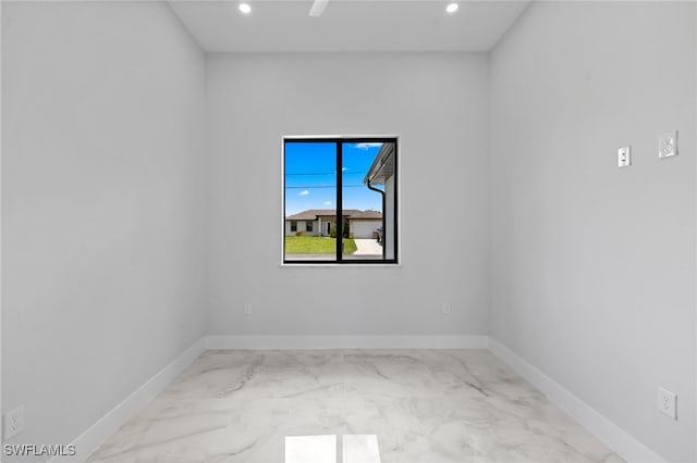 2513 13th St SW, Lehigh Acres, FL 33976 - unfurnished room with marble look tile flooring, recessed lighting, and baseboards