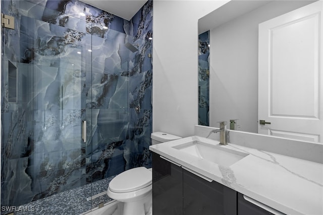 2513 13th St SW, Lehigh Acres, FL 33976 - bathroom featuring vanity, toilet, and a marble finish shower