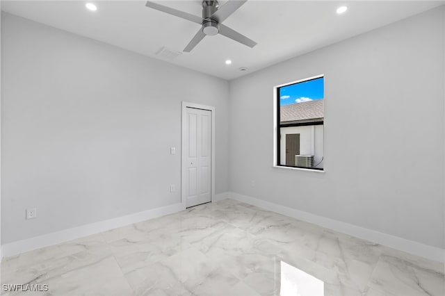 2513 13th St SW, Lehigh Acres, FL 33976 - empty room featuring recessed lighting, marble look tile flooring, a ceiling fan, and baseboards