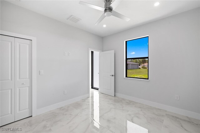 2513 13th St SW, Lehigh Acres, FL 33976 - unfurnished bedroom featuring light marble finish flooring, baseboards, recessed lighting, a closet, and ceiling fan