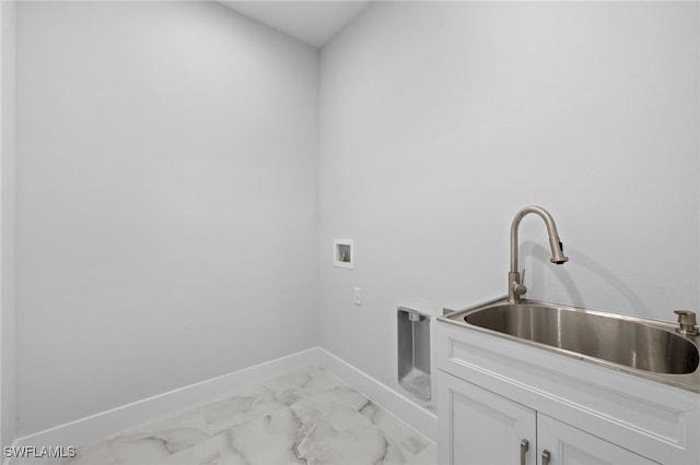 2513 13th St SW, Lehigh Acres, FL 33976 - laundry room featuring cabinet space, baseboards, light marble finish floors, and washer hookup