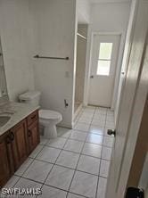 718 Jefferson Ave, Lehigh Acres, FL 33936 - bathroom with vanity, a stall shower, tile patterned floors, and toilet