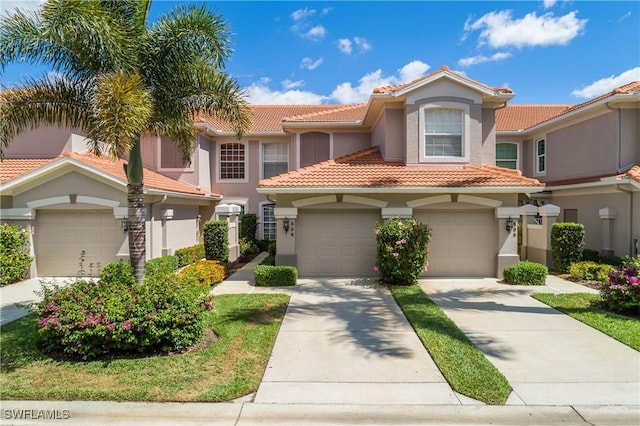 23560 Wisteria Pointe Dr Unit 506, Estero, FL 34135 - view of front facade with stucco siding, driveway, a tile roof, and a garage
