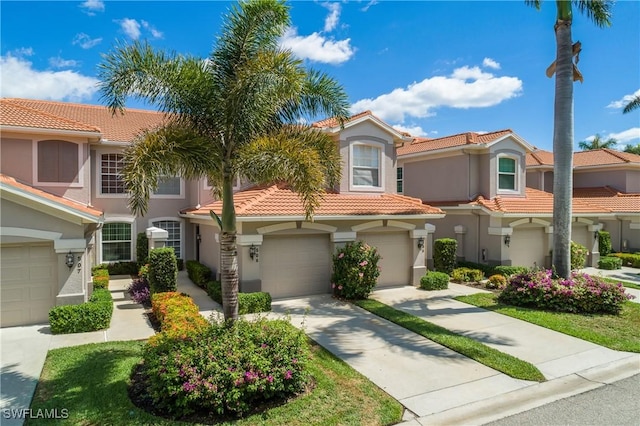 23560 Wisteria Pointe Dr Unit 506, Estero, FL 34135 - mediterranean / spanish home with stucco siding, a tiled roof, driveway, and a garage
