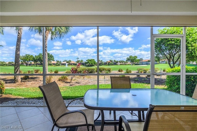 23560 Wisteria Pointe Dr Unit 506, Estero, FL 34135 - sunroom / solarium featuring view of golf course and outdoor dining space