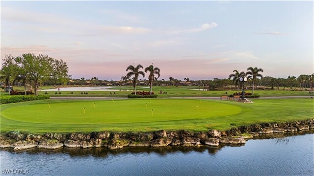 23560 Wisteria Pointe Dr Unit 506, Estero, FL 34135 - view of community with a putting area, a water view, golf course view, and a yard