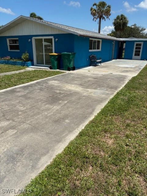 1610 Woodlawn Ave, Punta Gorda, FL 33950 - view of front of property featuring a front lawn and concrete driveway
