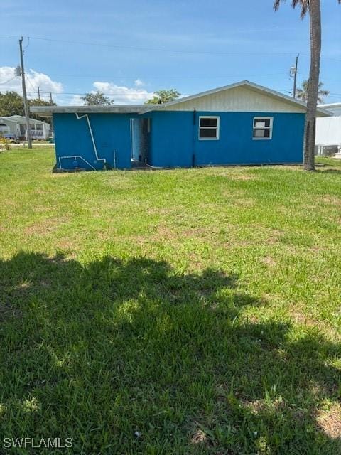 1610 Woodlawn Ave, Punta Gorda, FL 33950 - rear view of house featuring a yard and stucco siding