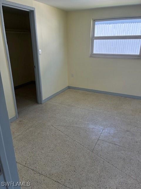 1610 Woodlawn Ave, Punta Gorda, FL 33950 - spare room featuring speckle patterned floor and baseboards