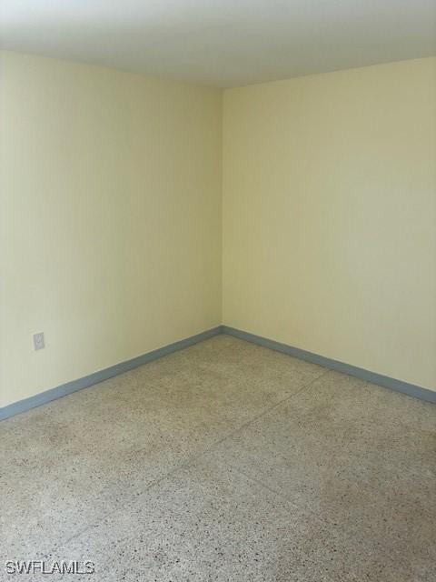 1610 Woodlawn Ave, Punta Gorda, FL 33950 - unfurnished room with dark aggregate flooring and baseboards
