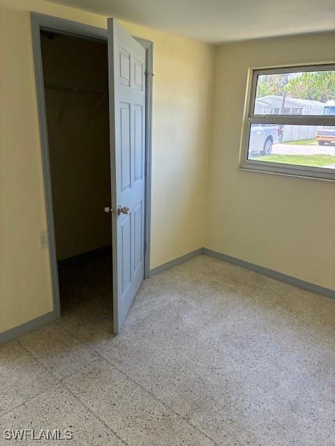 1610 Woodlawn Ave, Punta Gorda, FL 33950 - unfurnished bedroom with baseboards and a walk in closet
