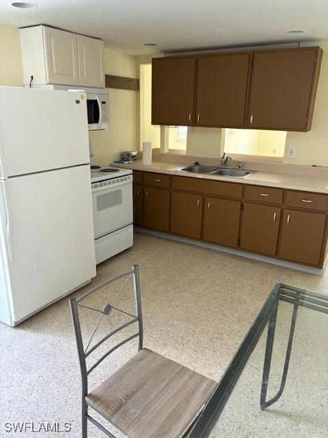 1610 Woodlawn Ave, Punta Gorda, FL 33950 - kitchen with white appliances, a sink, and light countertops
