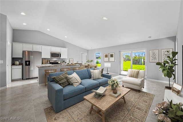 3213 NW 4th Ave, Cape Coral, FL 33993 - living room with vaulted ceiling, recessed lighting, baseboards, and light tile patterned flooring