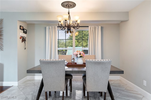 2313 Hines Ave, Alva, FL 33920 - dining area featuring a chandelier, baseboards, and light marble finish flooring