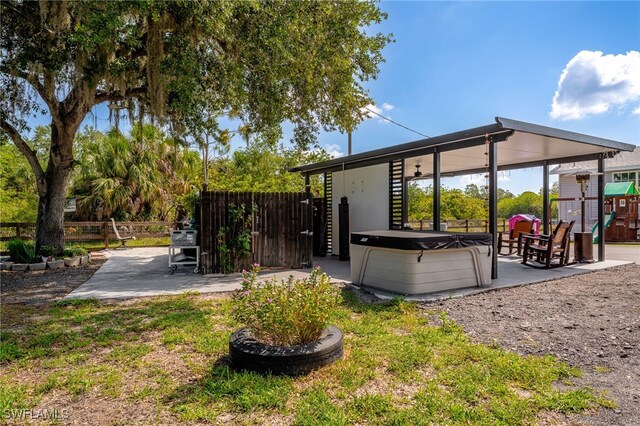 2313 Hines Ave, Alva, FL 33920 - rear view of house with a hot tub and a patio area