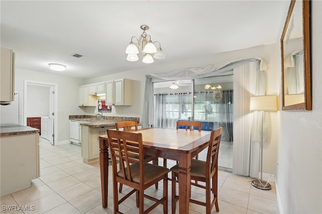426 Chestnut Ave NW, Port Charlotte, FL 33952 - dining room featuring light tile patterned floors, a chandelier, and baseboards