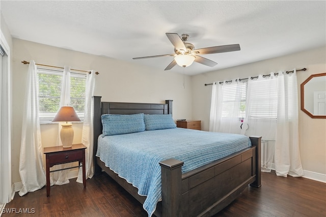 426 Chestnut Ave NW, Port Charlotte, FL 33952 - bedroom with dark wood-style flooring, baseboards, and ceiling fan