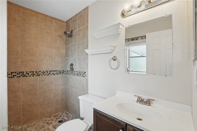 426 Chestnut Ave NW, Port Charlotte, FL 33952 - bathroom featuring vanity, a tile shower, and toilet