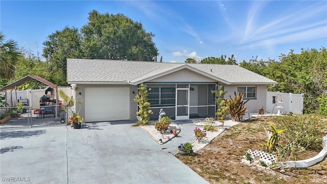 426 Chestnut Ave NW, Port Charlotte, FL 33952 - ranch-style house featuring stucco siding, driveway, an attached garage, a sunroom, and a gate