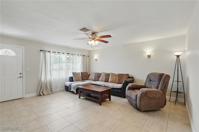 426 Chestnut Ave NW, Port Charlotte, FL 33952 - living room with ceiling fan, light tile patterned floors, and baseboards