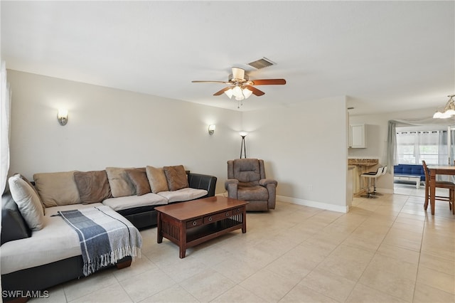 426 Chestnut Ave NW, Port Charlotte, FL 33952 - living room featuring a ceiling fan, light tile patterned floors, baseboards, and a chandelier