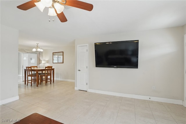 426 Chestnut Ave NW, Port Charlotte, FL 33952 - living area featuring ceiling fan, light tile patterned floors, baseboards, and a chandelier