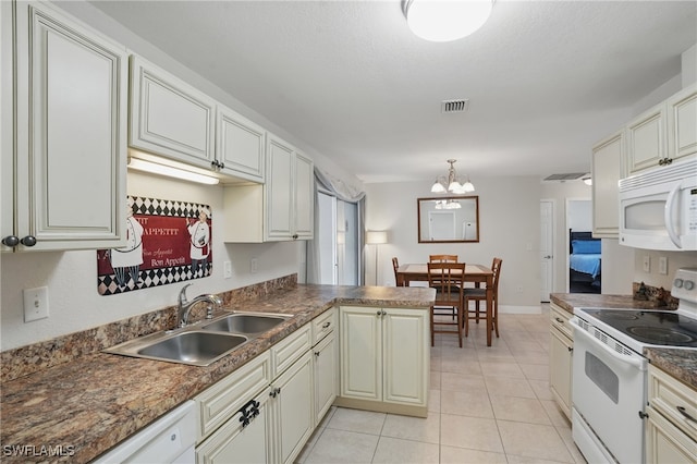 426 Chestnut Ave NW, Port Charlotte, FL 33952 - kitchen featuring white appliances, a sink, a chandelier, light tile patterned floors, and dark countertops