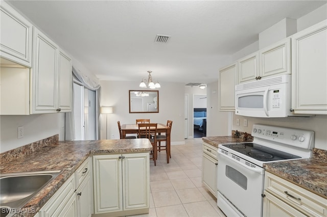 426 Chestnut Ave NW, Port Charlotte, FL 33952 - kitchen featuring white appliances, dark countertops, a chandelier, light tile patterned flooring, and a sink