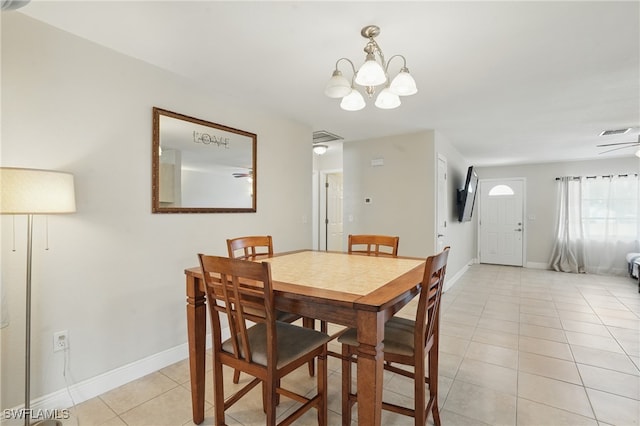 426 Chestnut Ave NW, Port Charlotte, FL 33952 - dining area with light tile patterned floors, a chandelier, and baseboards